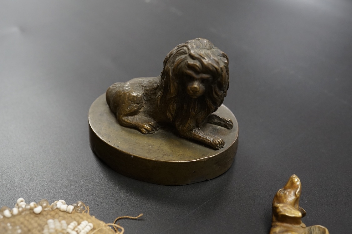 19th century objects to include a bronze lion paperweight, a Palais Royale chamberstick, a beadwork pocket, chatelaine etc